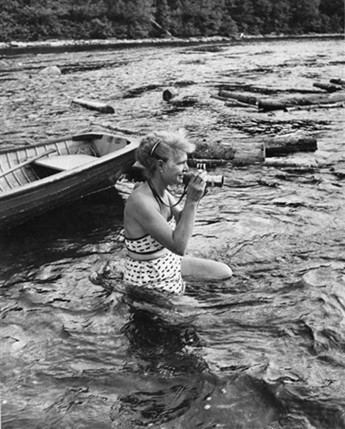 Margaret Bourke-White photographing in the Kennebec River, Maine, circa 1950